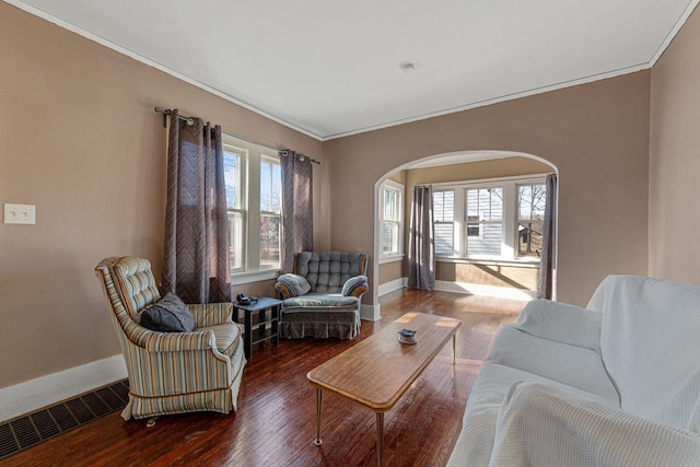 living room with hardwood / wood-style flooring and crown molding