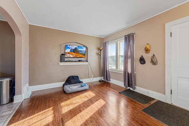 unfurnished room with hardwood / wood-style flooring and ornamental molding