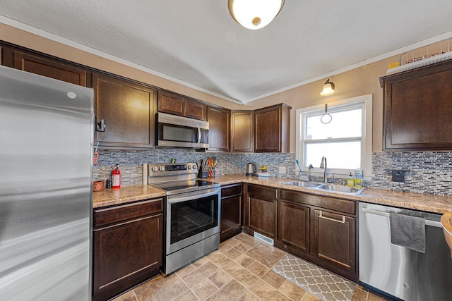 kitchen with appliances with stainless steel finishes, sink, dark brown cabinetry, and decorative backsplash