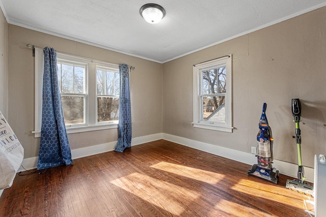 interior space with hardwood / wood-style flooring, a healthy amount of sunlight, crown molding, and a textured ceiling