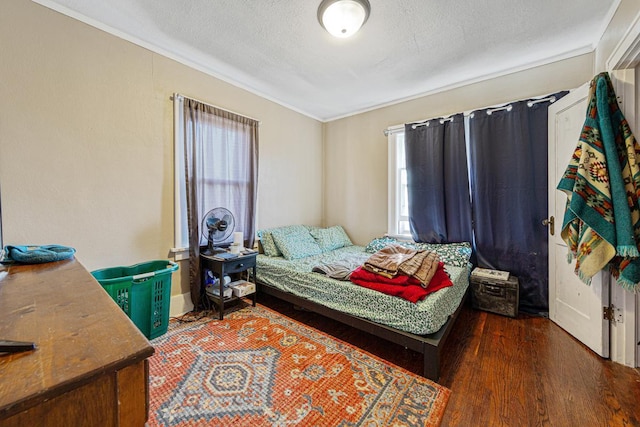 bedroom featuring dark hardwood / wood-style flooring and a textured ceiling