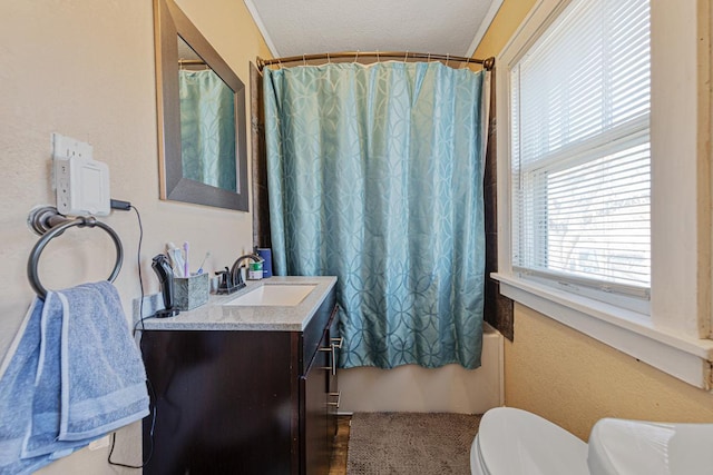 full bathroom featuring vanity, toilet, shower / tub combo, and a textured ceiling