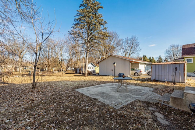 view of yard with a storage shed and a patio