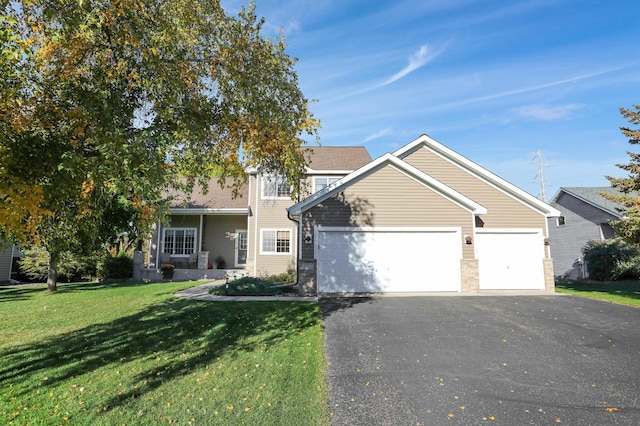 view of front of property featuring a garage and a front yard