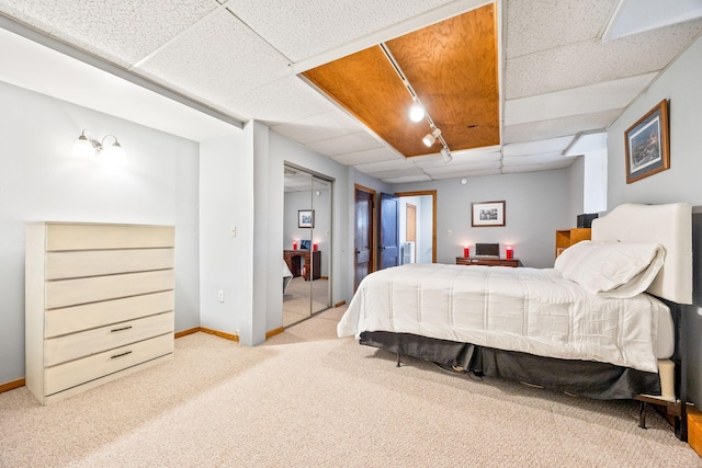 bedroom with baseboards, a paneled ceiling, and carpet floors