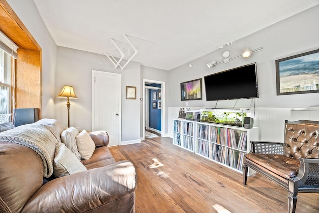 living area featuring baseboards and wood finished floors