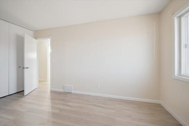 spare room with light hardwood / wood-style flooring