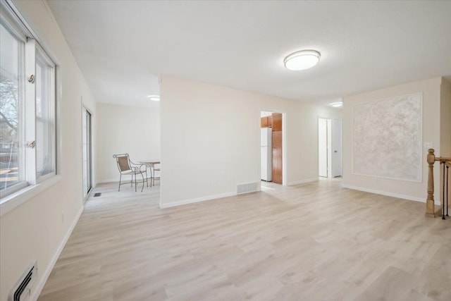 unfurnished room with light wood-type flooring