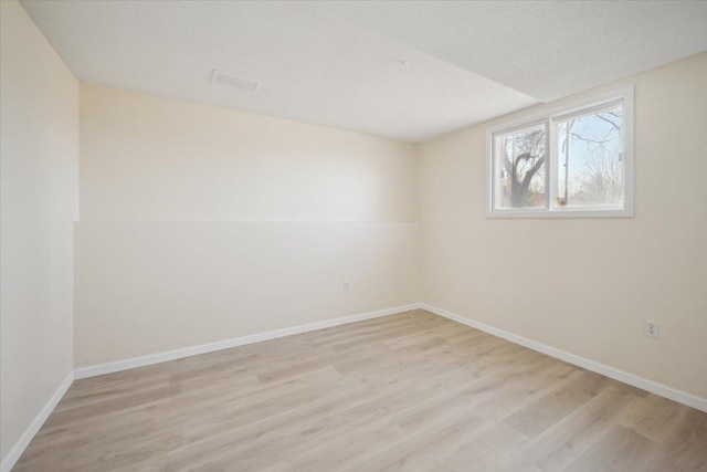 spare room with light hardwood / wood-style flooring