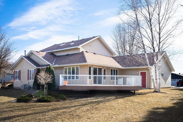 rear view of property with a yard and a deck