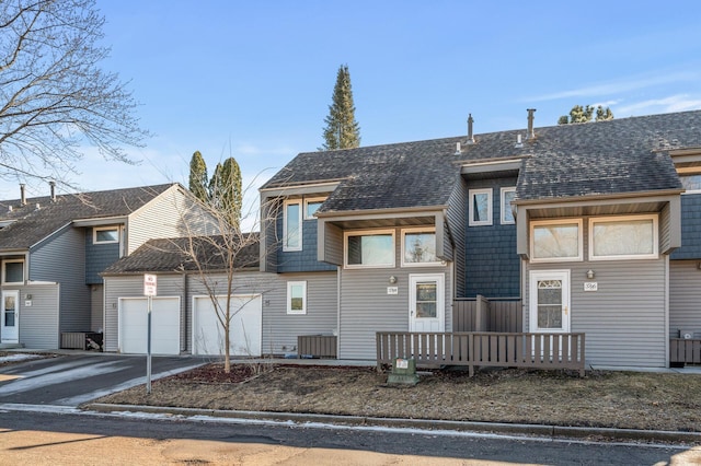 exterior space featuring concrete driveway, roof with shingles, and an attached garage