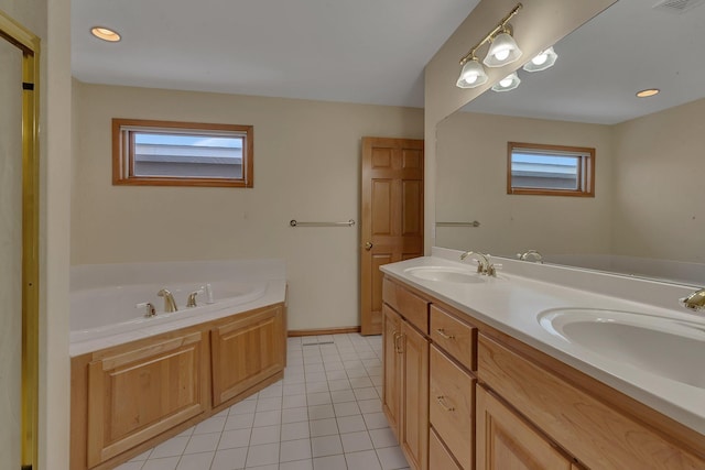 bathroom with tile patterned flooring, a tub to relax in, and vanity