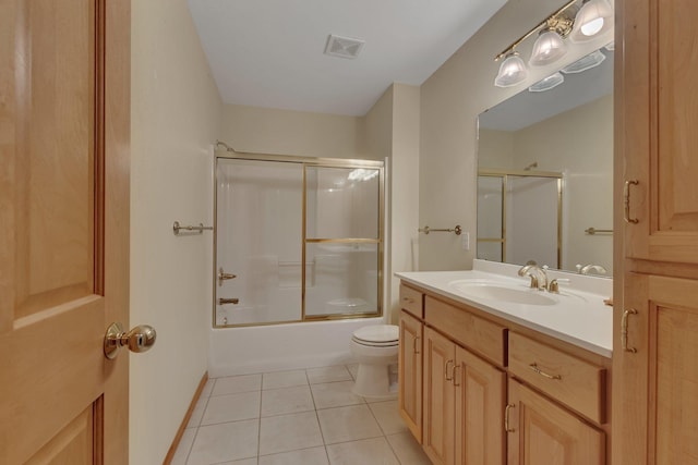 full bathroom with tile patterned flooring, vanity, enclosed tub / shower combo, and toilet