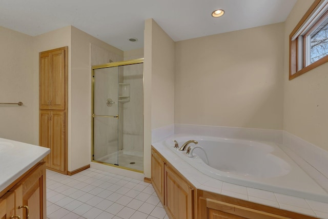 bathroom with vanity, tile patterned flooring, and plus walk in shower