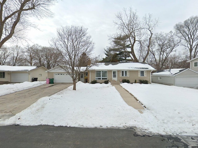 ranch-style house featuring a detached garage