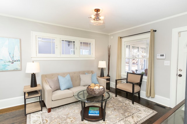 living room featuring crown molding, hardwood / wood-style flooring, and a chandelier