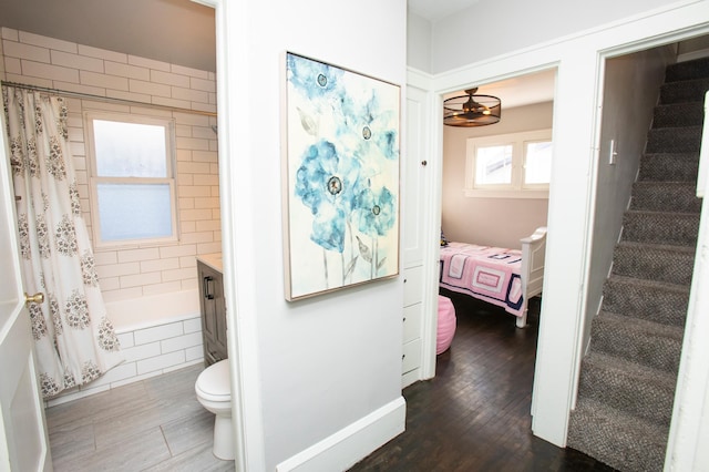 full bathroom with shower / bath combination with curtain, wood-type flooring, toilet, and vanity