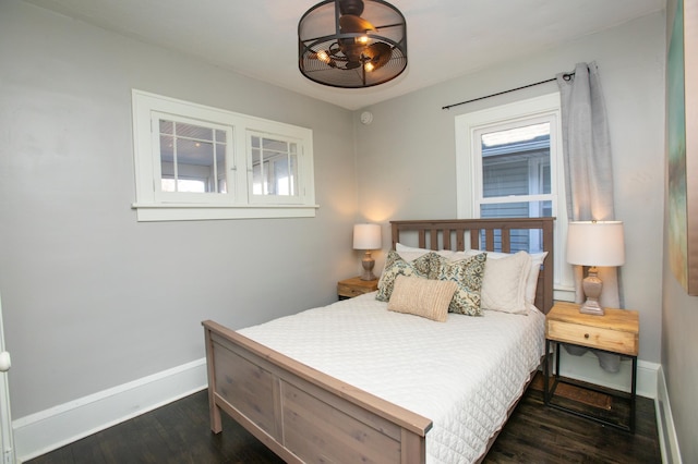 bedroom with dark wood-type flooring