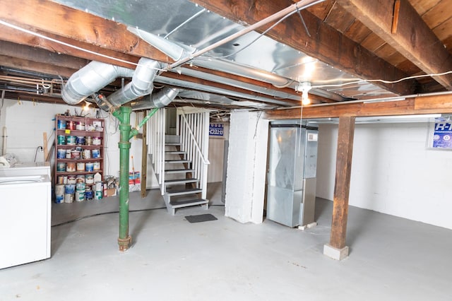 basement featuring washing machine and dryer and heating unit