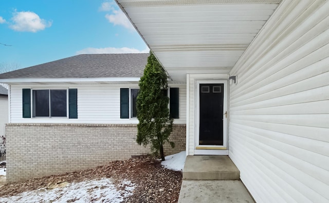 view of snow covered property entrance