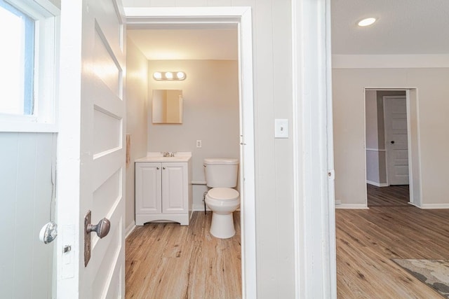 bathroom with vanity, hardwood / wood-style floors, and toilet