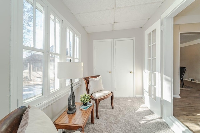 interior space with carpet, a paneled ceiling, and french doors