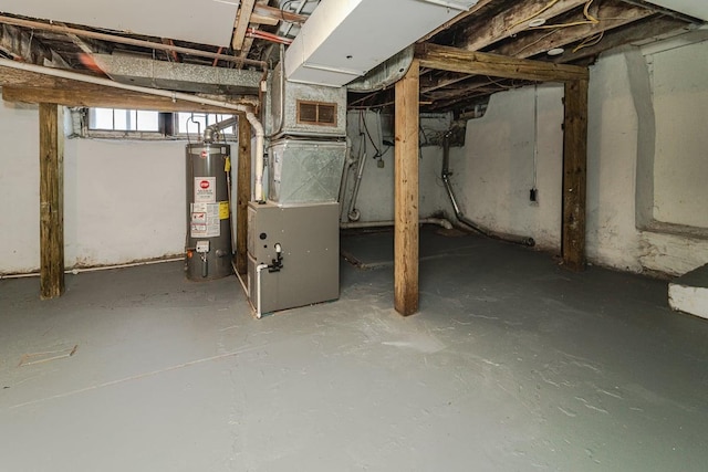 basement featuring heating unit and gas water heater