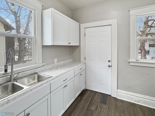 906 12th St N, Fargo, ND 58102 - kitchen featuring sink, dark wood-type flooring, and white cabinets