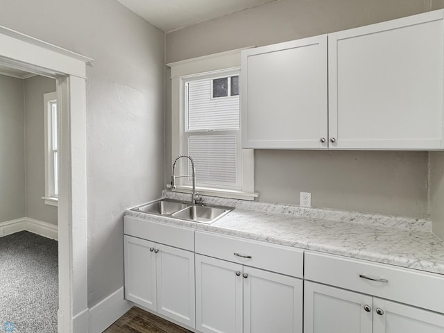 906 12th St N, Fargo, ND 58102 - kitchen with plenty of natural light, sink, and white cabinets