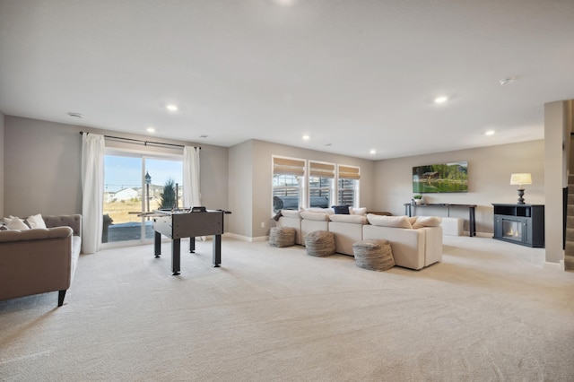 living room with a fireplace and light colored carpet