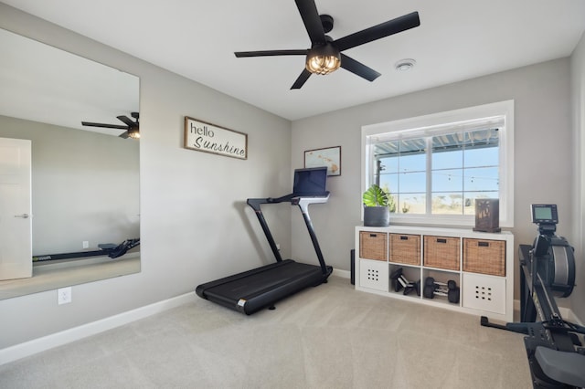 workout area with ceiling fan and light carpet