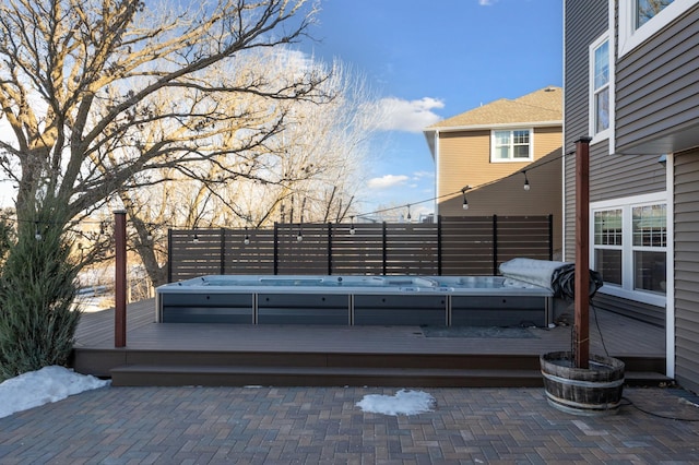 deck featuring an outdoor hot tub