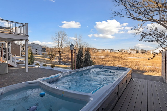 wooden deck with a hot tub