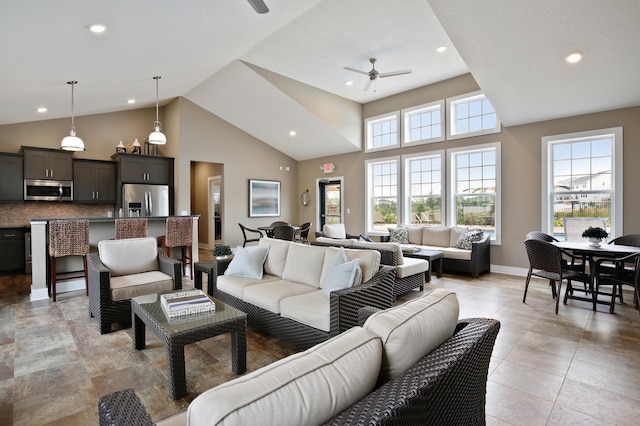 living room with light tile patterned floors, high vaulted ceiling, and ceiling fan