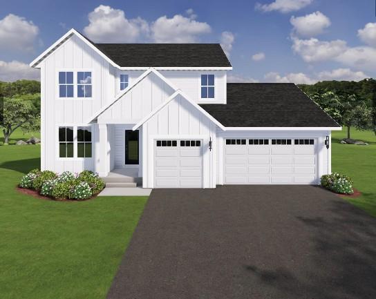 view of front of house with a garage and a front yard