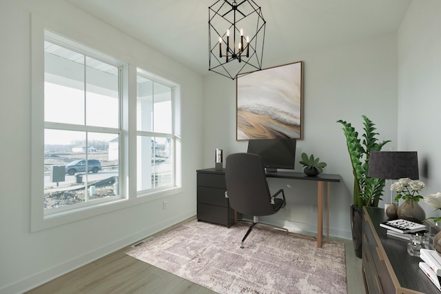 office space featuring an inviting chandelier and wood-type flooring