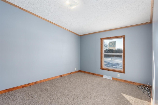 unfurnished room with ornamental molding, carpet flooring, and a textured ceiling