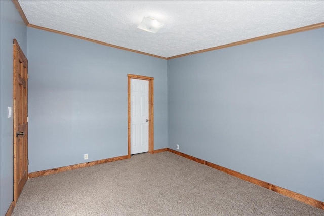 carpeted empty room featuring crown molding and a textured ceiling