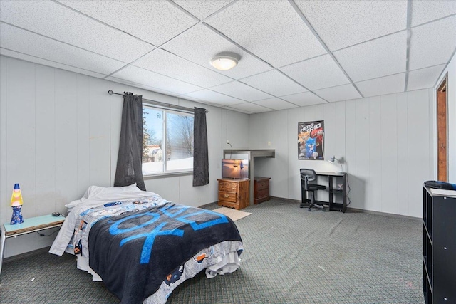 bedroom with carpet floors and a drop ceiling