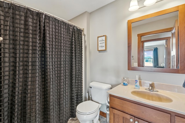 bathroom with vanity, a shower with shower curtain, and toilet