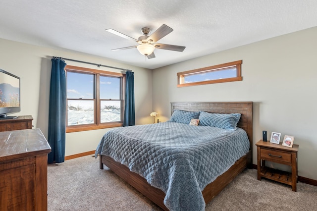 bedroom featuring ceiling fan, carpet flooring, and a textured ceiling