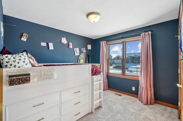 carpeted bedroom featuring a textured ceiling