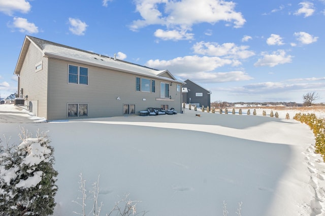 view of snow covered rear of property