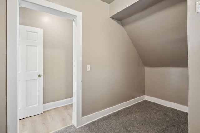 bonus room featuring lofted ceiling, carpet, and baseboards