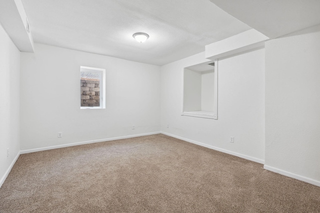 carpeted empty room with baseboards