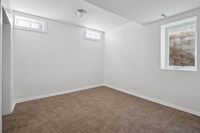 below grade area featuring carpet floors, baseboards, and visible vents