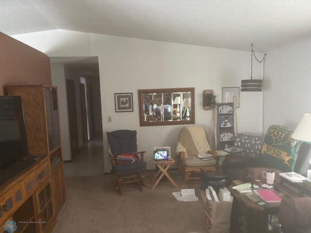 carpeted living room featuring lofted ceiling