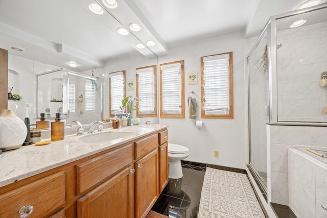 bathroom featuring vanity, toilet, a shower with shower door, and tile patterned flooring