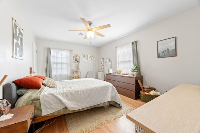 bedroom with ceiling fan and light hardwood / wood-style floors