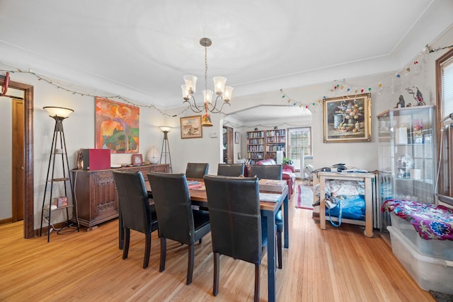 dining room featuring an inviting chandelier and light hardwood / wood-style flooring